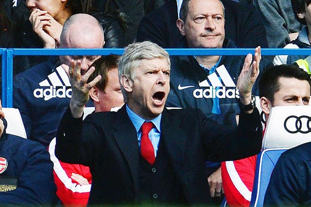 Arsene Wenger gestures from the dugout at Stamford Bridge during Arsenal's 6-0 defeat to Chelsea