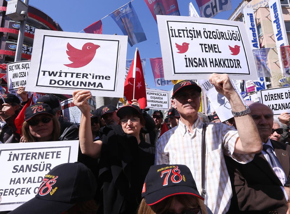 Protesters hold placards reading 'do not touch my twitter' and 'communication right is a basic human right' during a demonstration in Ankara against the Turkish ban on Twitter 