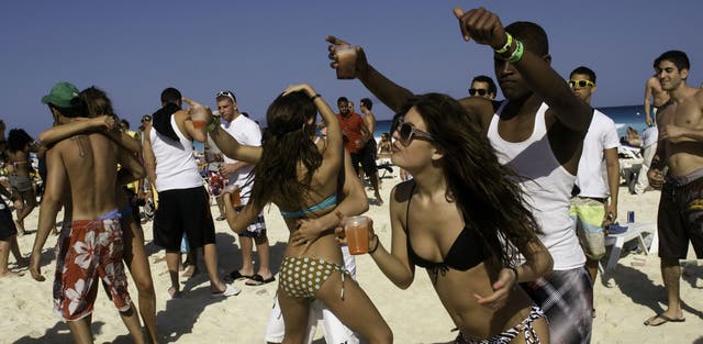 <p>Spring breakers on the beach in Cancun, Mexico, one of the most popular destinations for the traditional students’ rite of passage</p>