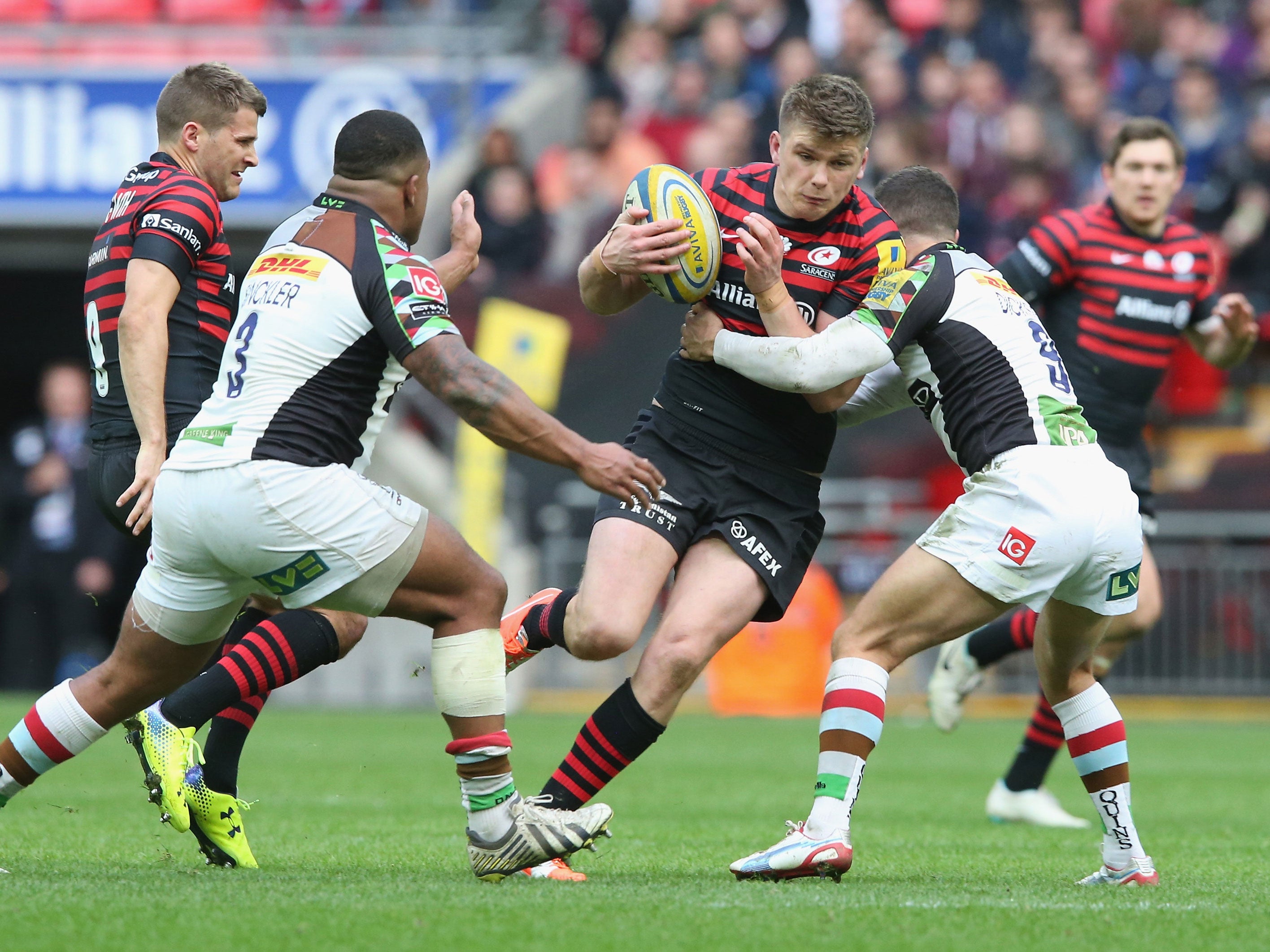 Owen Farrell is tackled by Harlequins' Karl Dickson as Kyle Sinckler closes in
