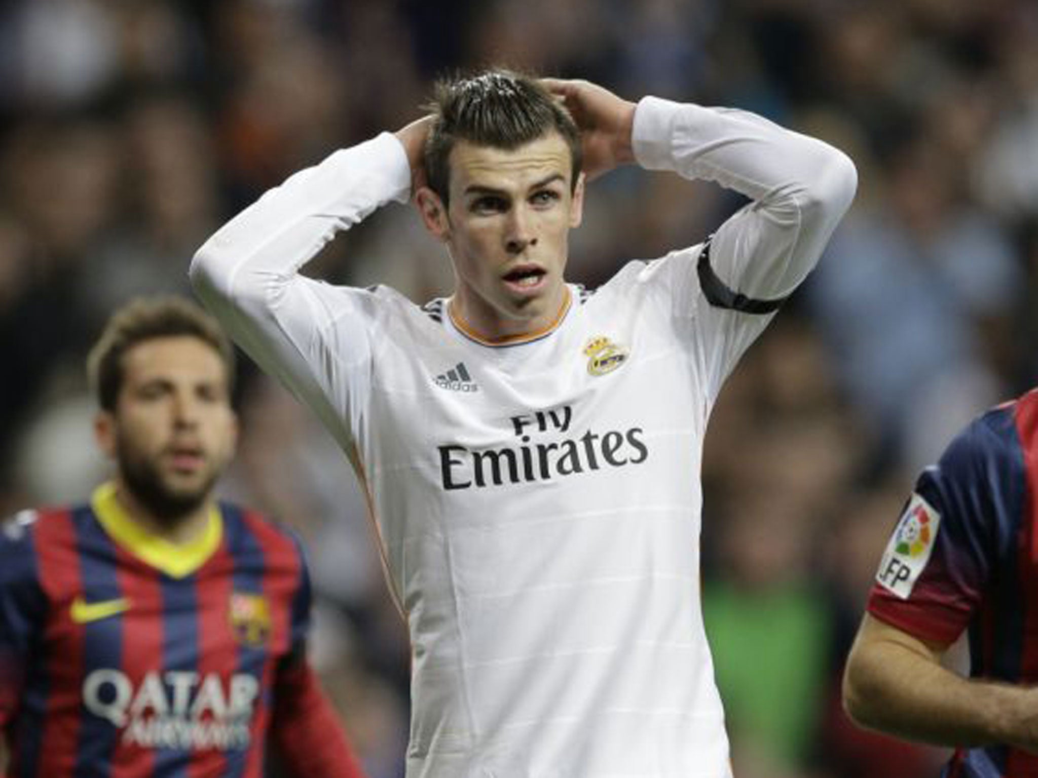 Gareth Bale (centre) looks on at the Bernabeu