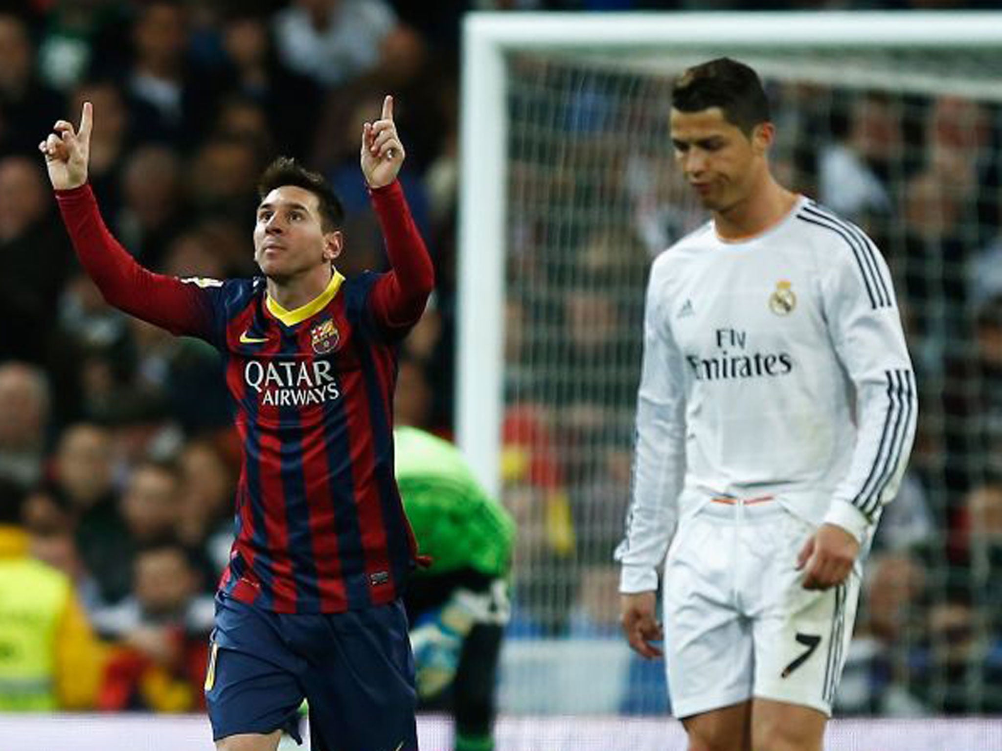 Lionel Messi celebrates scoring Barcelona's third goal as a downbeat Cristiano Ronaldo looks on