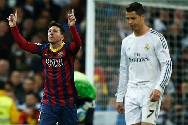 Lionel Messi celebrates scoring Barcelona's third goal as a downbeat Cristiano Ronaldo looks on