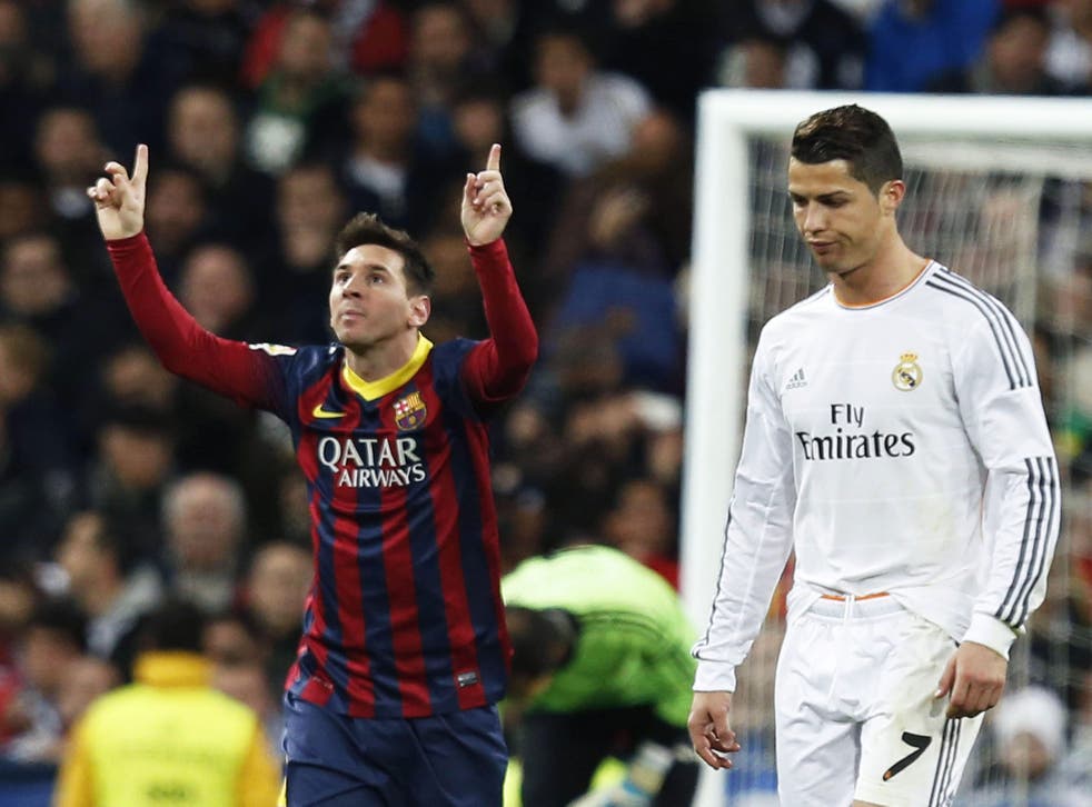 Lionel Messi,left, celebrates scoring the second of his three goals that helped Barcelona to a 4-3 victory over Cristiano Ronaldo’s Real Madrid at the Bernabeu