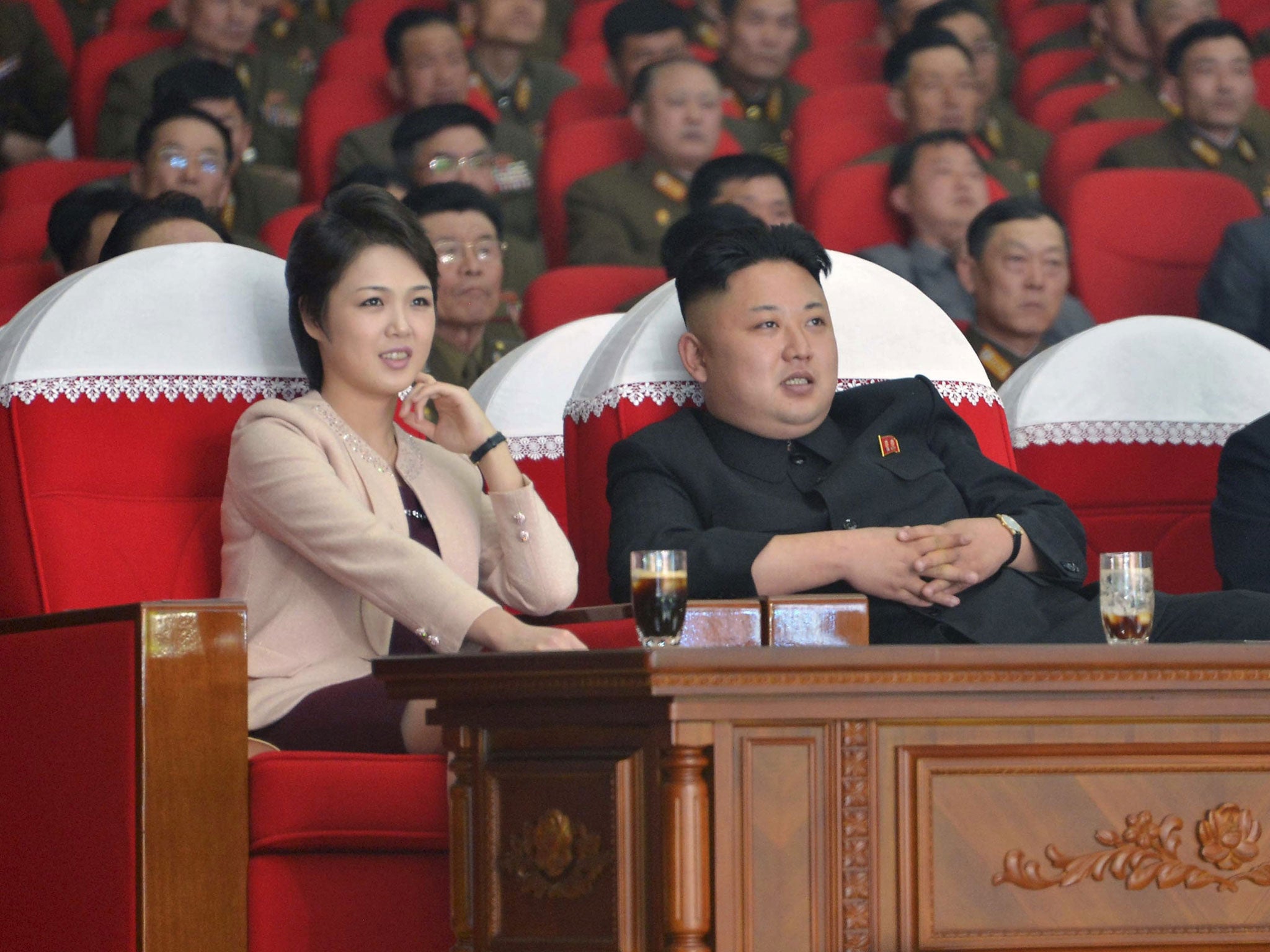 North Korean leader Kim Jong Un and his wife Ri Sol Ju watch a performance by the Moranbong Band at the April 25 House of Culture in Pyongyang