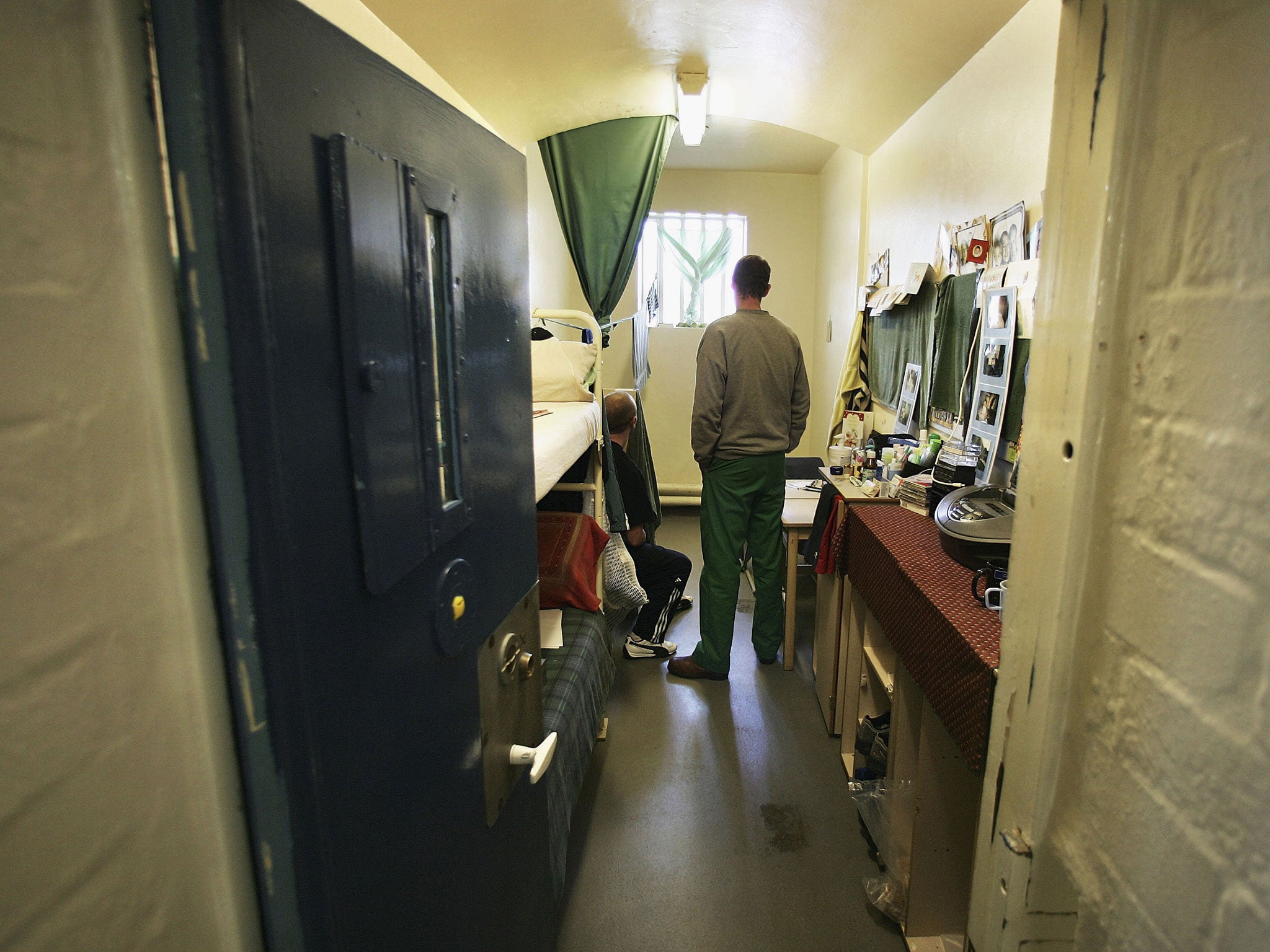 Prisoners look towards a window in a cell in A Wing of Norwich Prison in 2005.