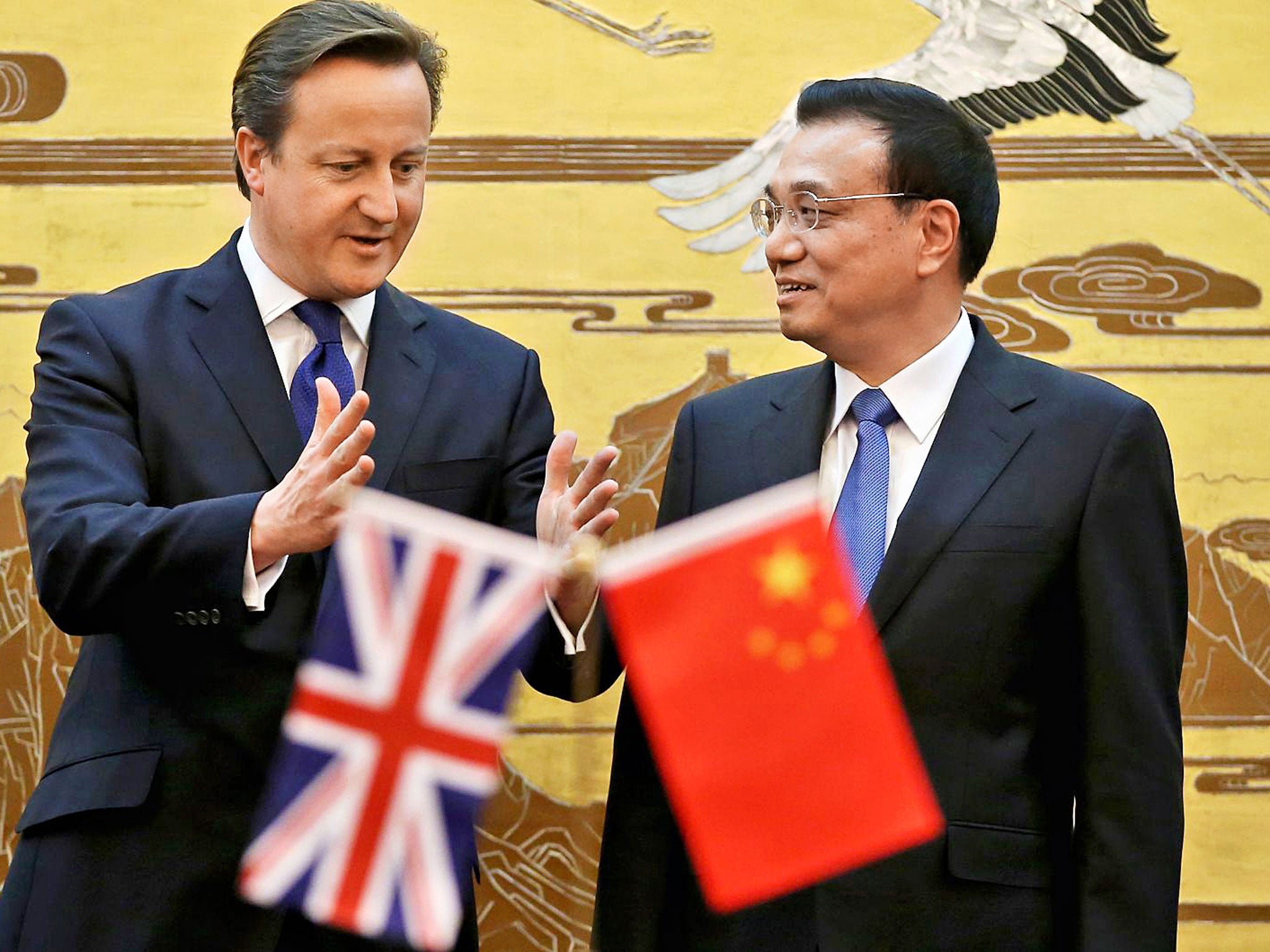 Minor player: David Cameron in Beijing with Chinese Premier Li Keqiang in December, 2013; a state controlled paper pointed out that Britain is not a major global power