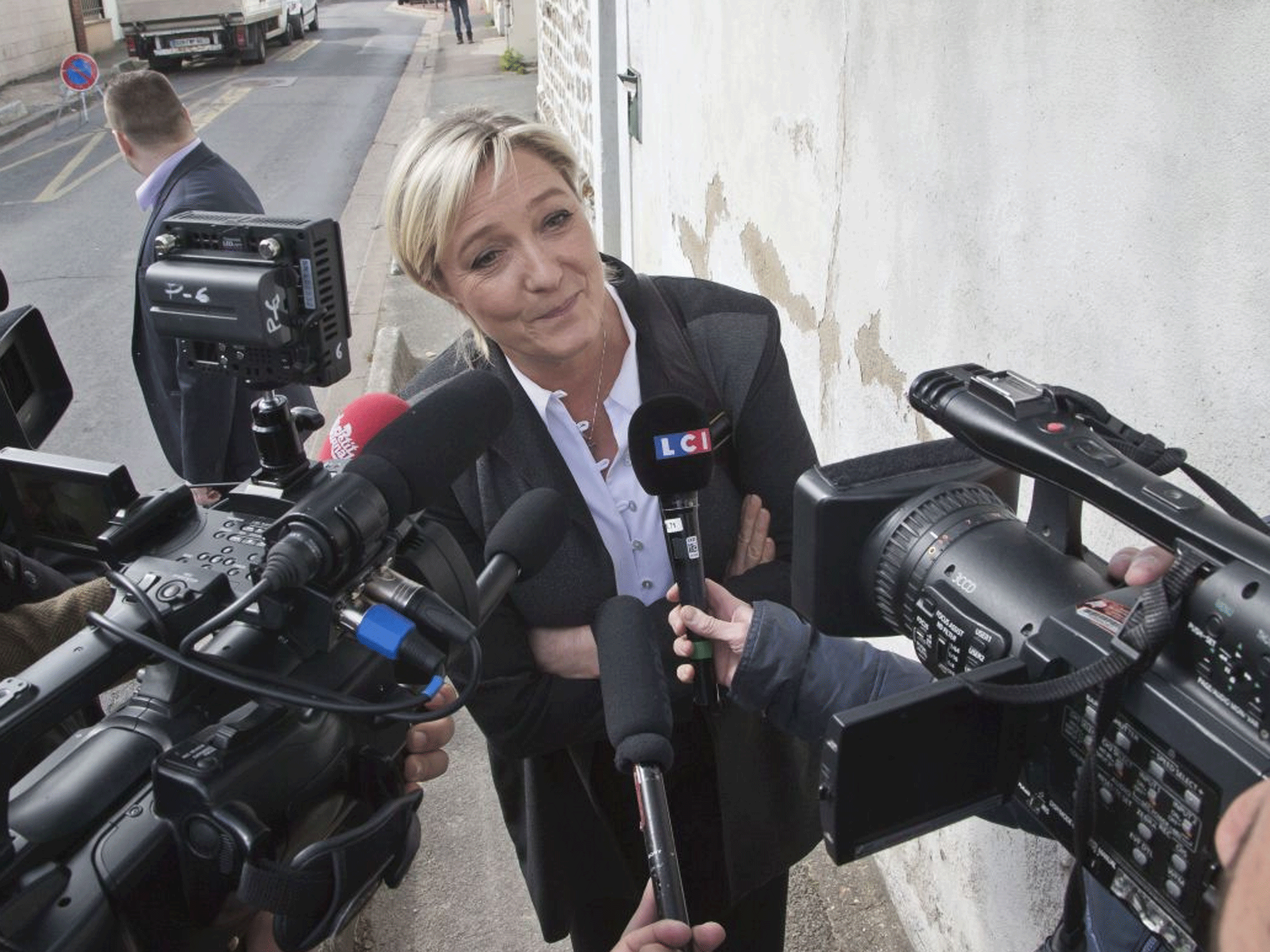 France's far right National Front leader Marine Le Pen, speaks to the media outside the party headquarters in Nanterre, west of Paris