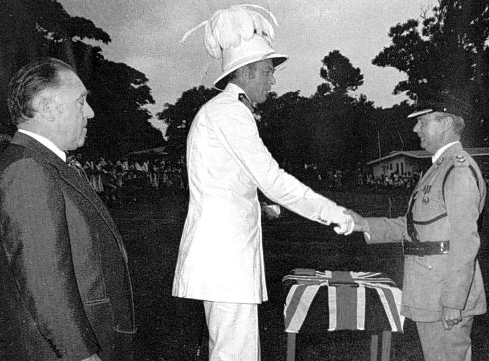 Stuart, centre, receives the British flag as Vanuatu becomes independent in 1981