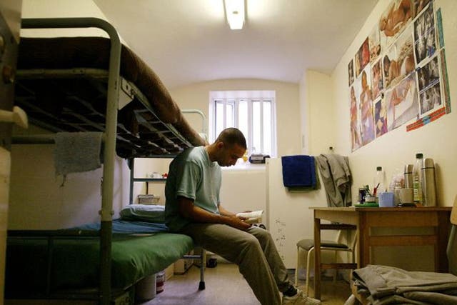 A prisoner reads a book in his cell at HMP Pentonville