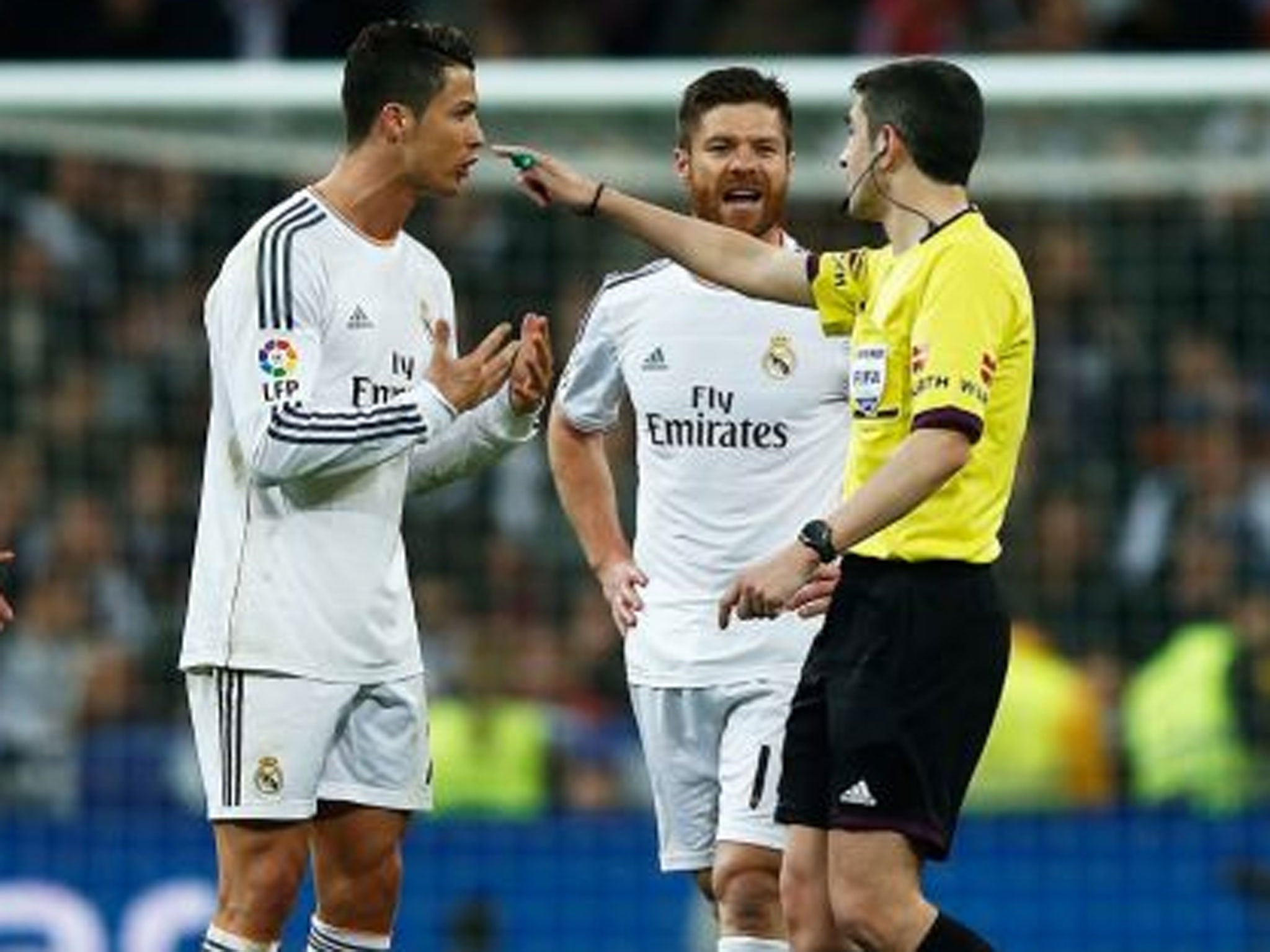 Cristiano Ronaldo tries to make his point to the referee during El Clasico