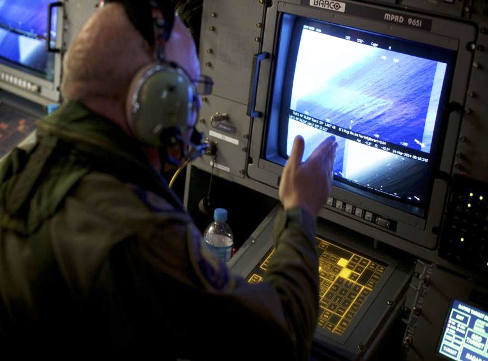 A crew member on board an RAAF AP-3C Orion aircraft looks at a radar screen whilst searching for missing Malaysia Airlines Flight MH370 over the Indian Ocean