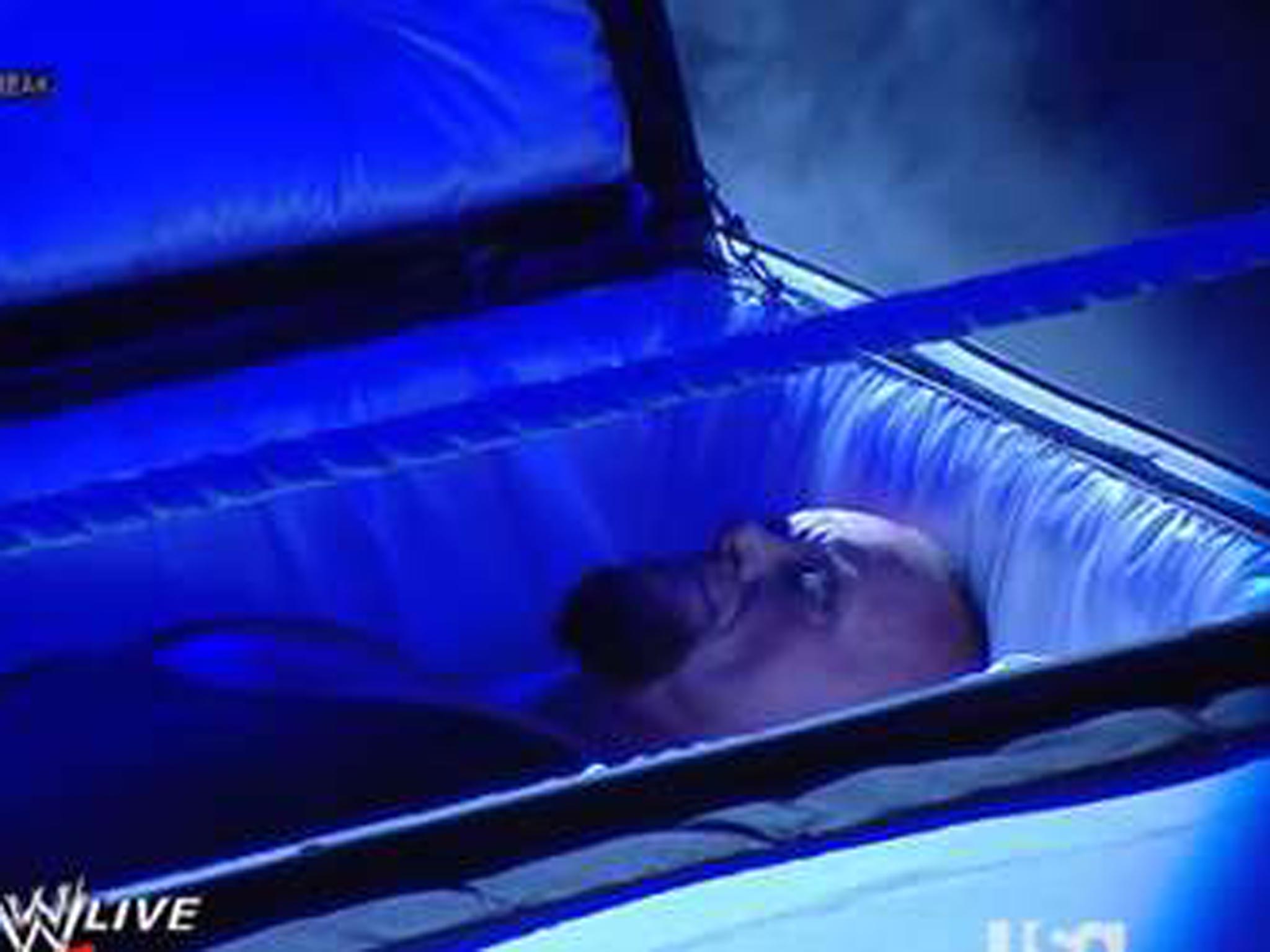 The Undertaker emerges from a casket to confront Brock Lesnar