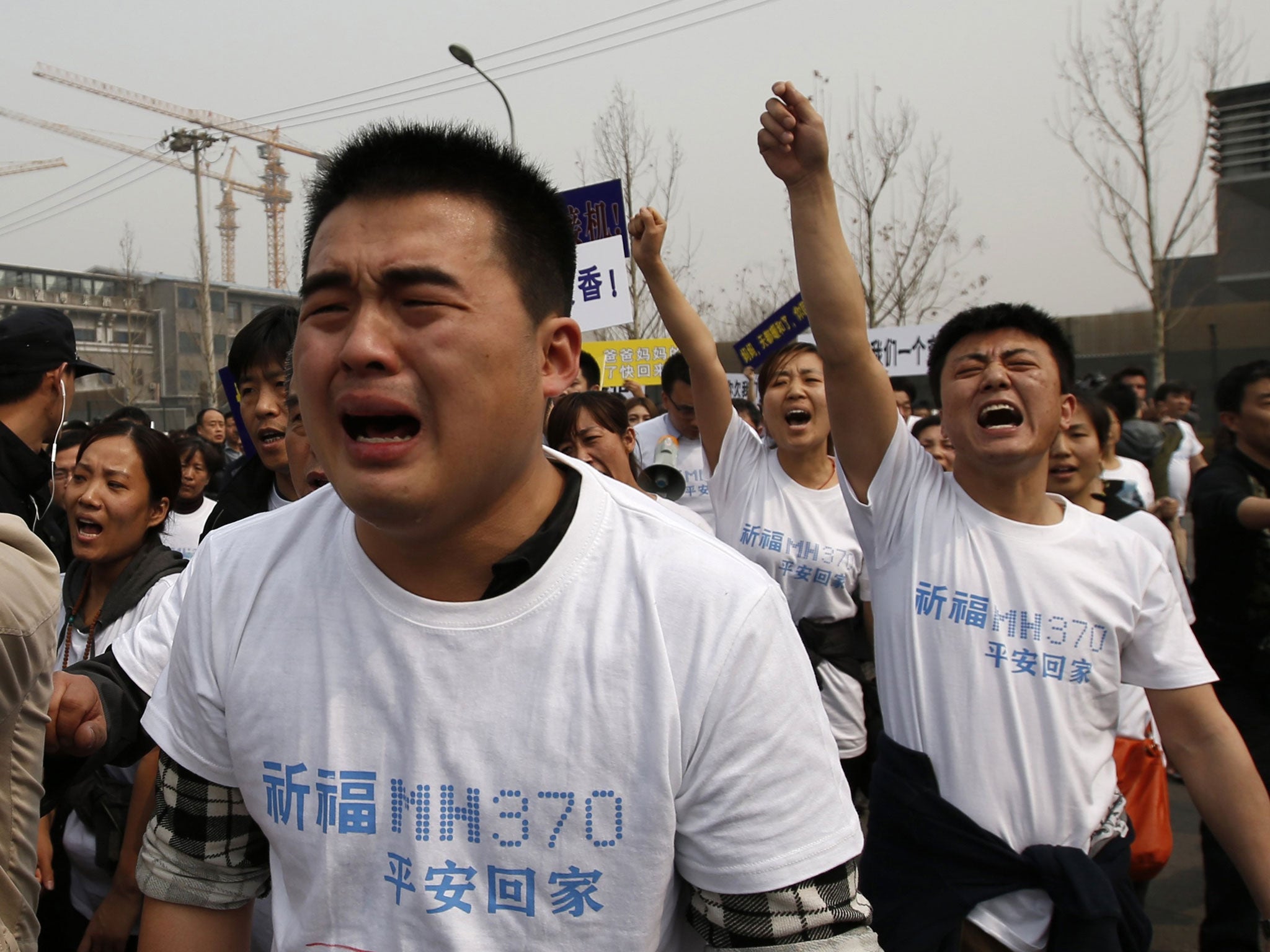 Dozens of angry relatives of passengers on the lost Malaysian jetliner clashed with police in Beijing on Tuesday, accusing the Southeast Asian country of "delays and deception"