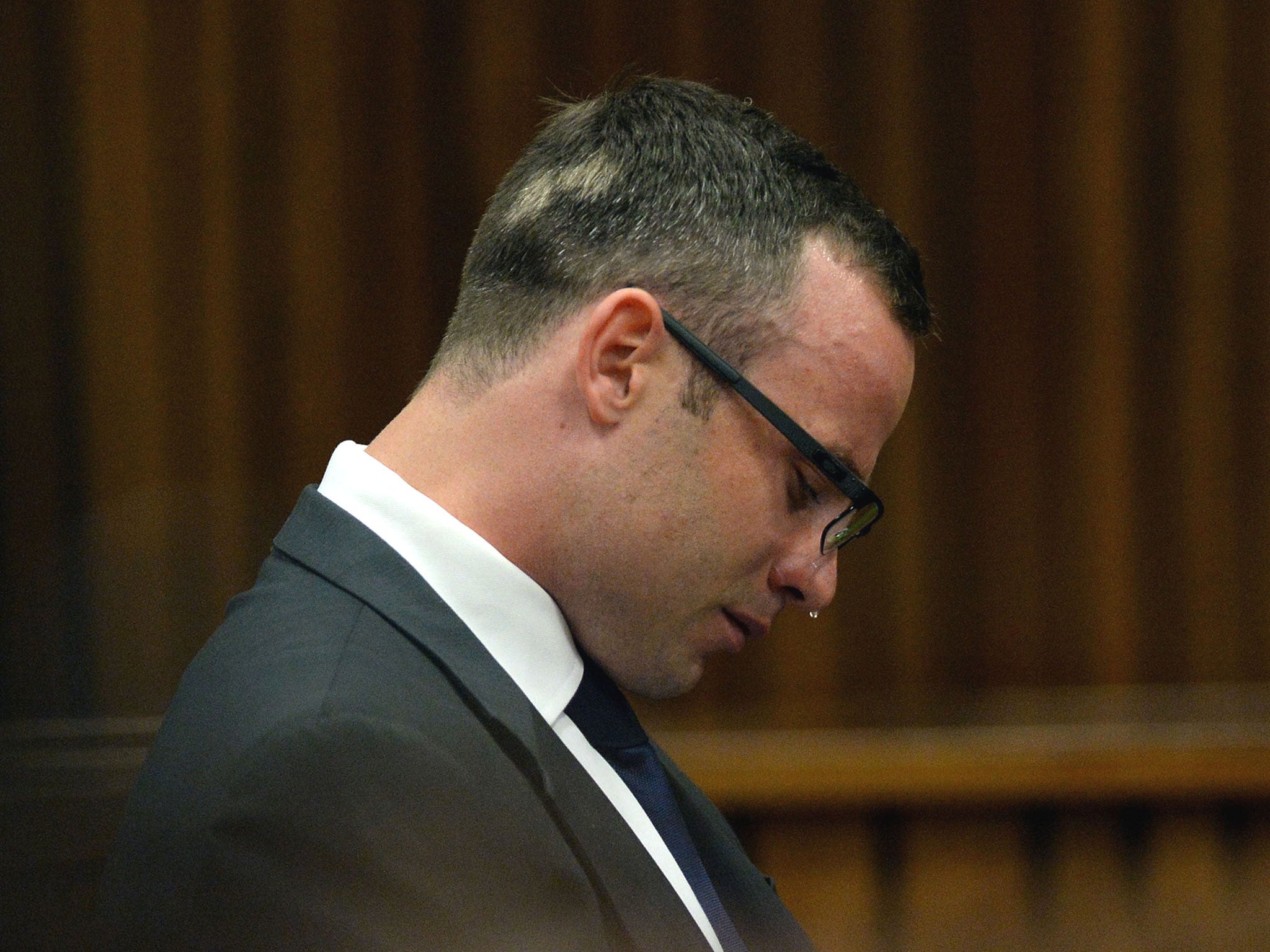 Oscar Pistorius cries as he sits in the dock during his ongoing murder trial in Pretoria