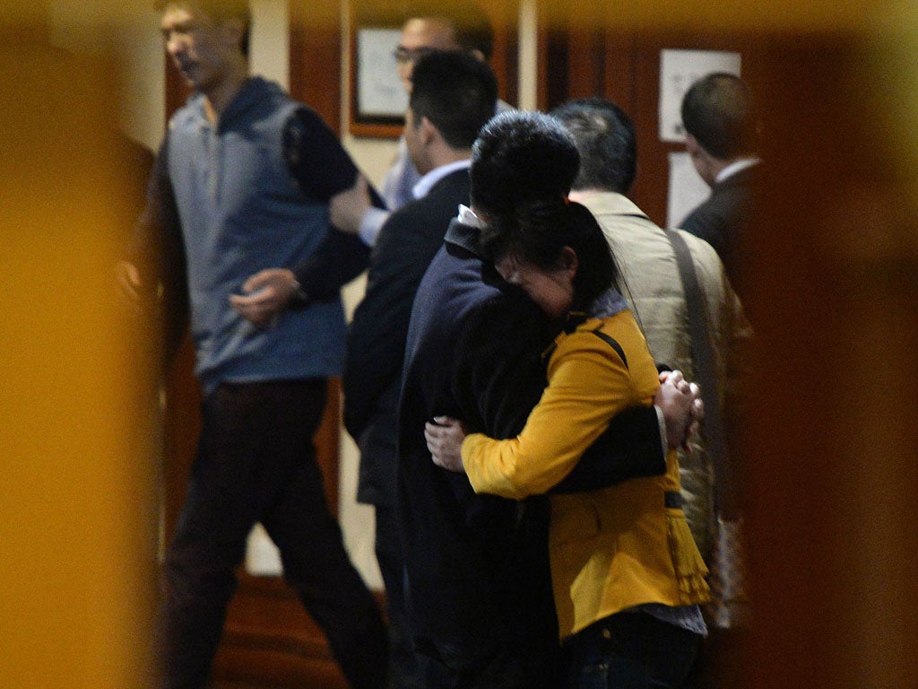Grieving Chinese relatives of passengers on the missing Malaysia Airlines flight MH370 react after being told of their deaths at the Metro Park Lido Hotel in Beijing on March 24, 2014.