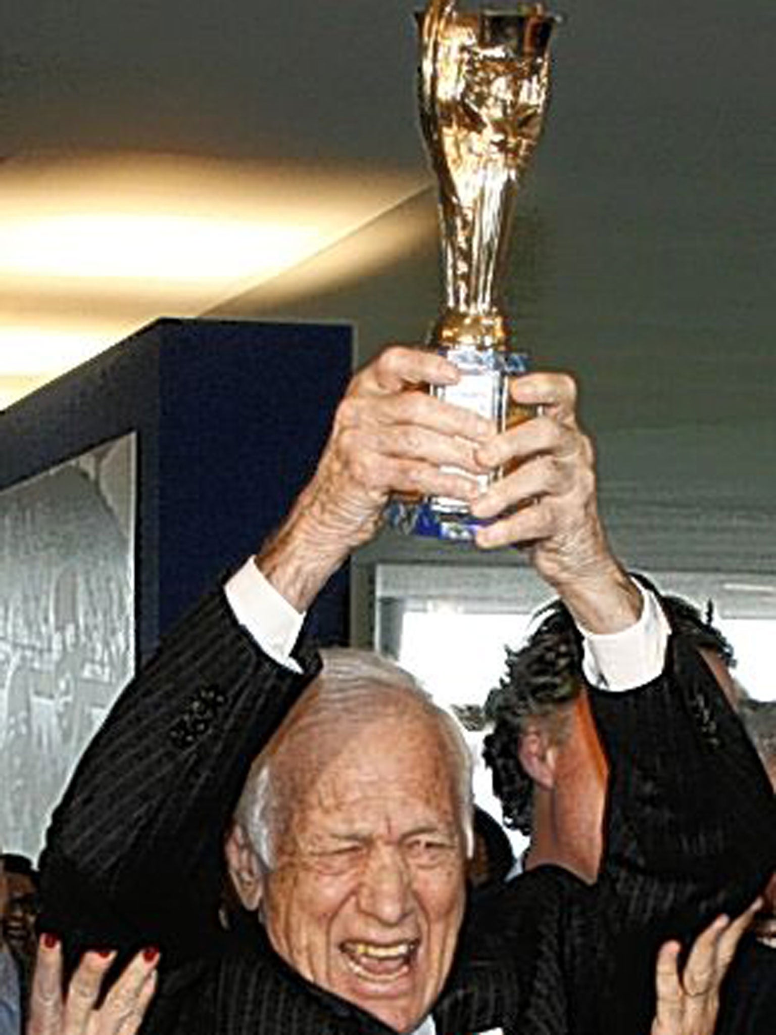 Bellini lifts a replica of the Jules Rimet trophy in a recreation of the seminal image from 1958
