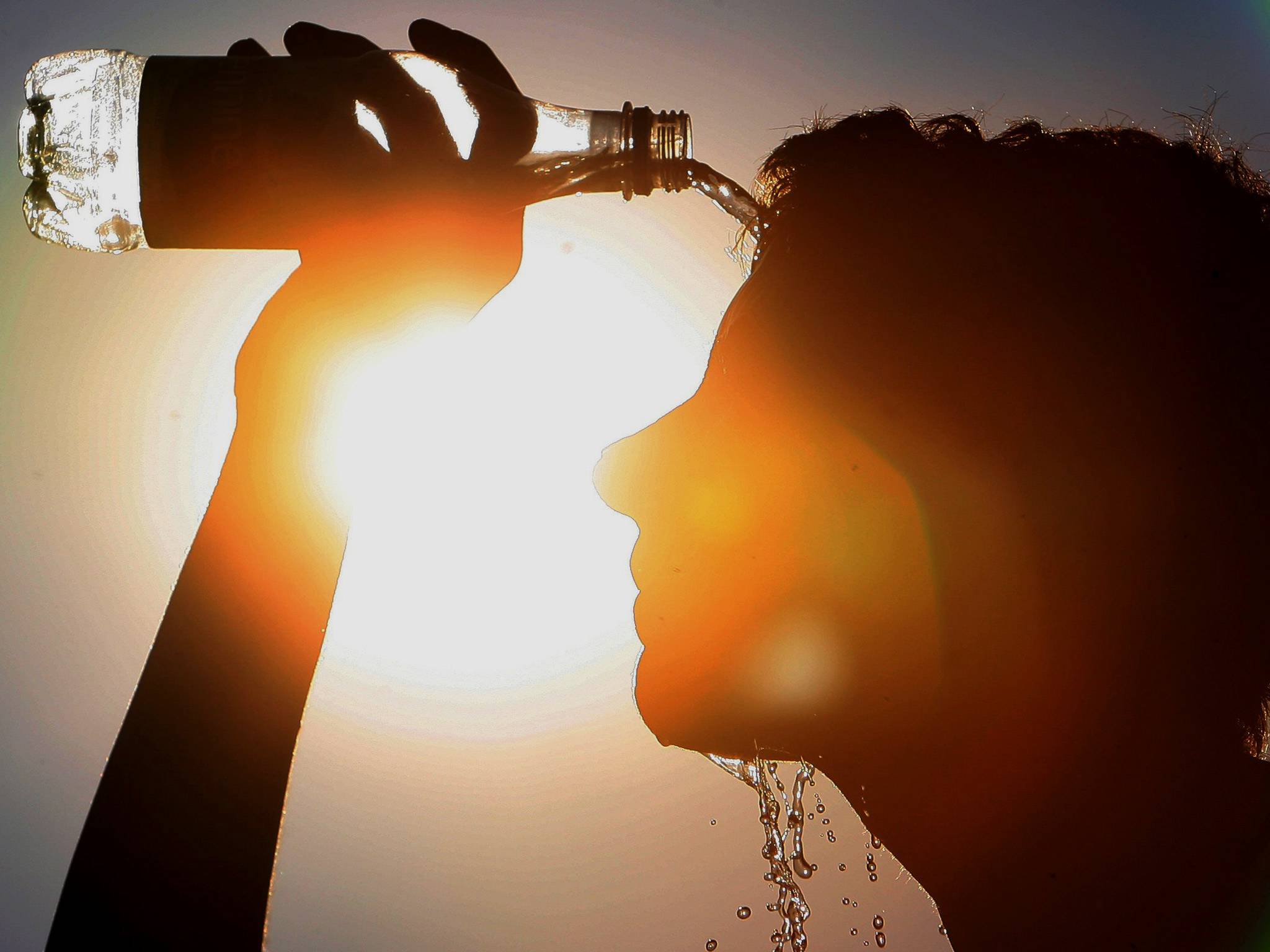 A man cools himself down. Hot summers are expected to become the norm by 2040