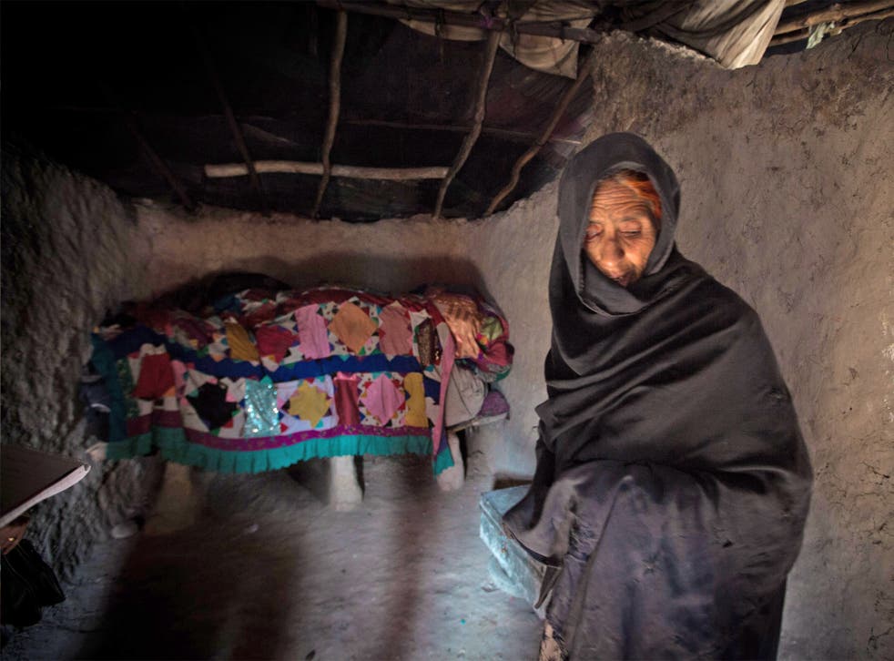 Niaz Bibi shelters in her mud-walled home in Kabul’s Nasaji Bagramy camp for internal refugees. Her family survives on charity handouts and the proceeds of her grandchildren’s begging
