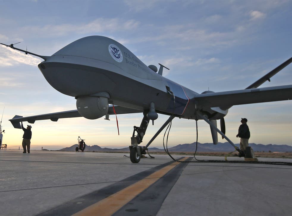 Maintenence personel check a US Predator drone at Fort Huachuca, Arizona