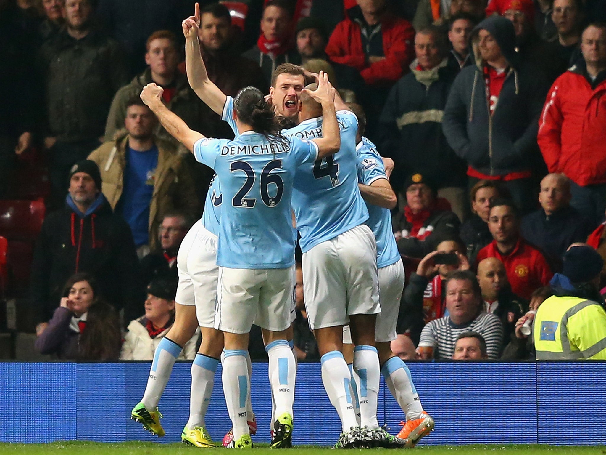 Manchester City players celebrate Edin Dzeko's early goal