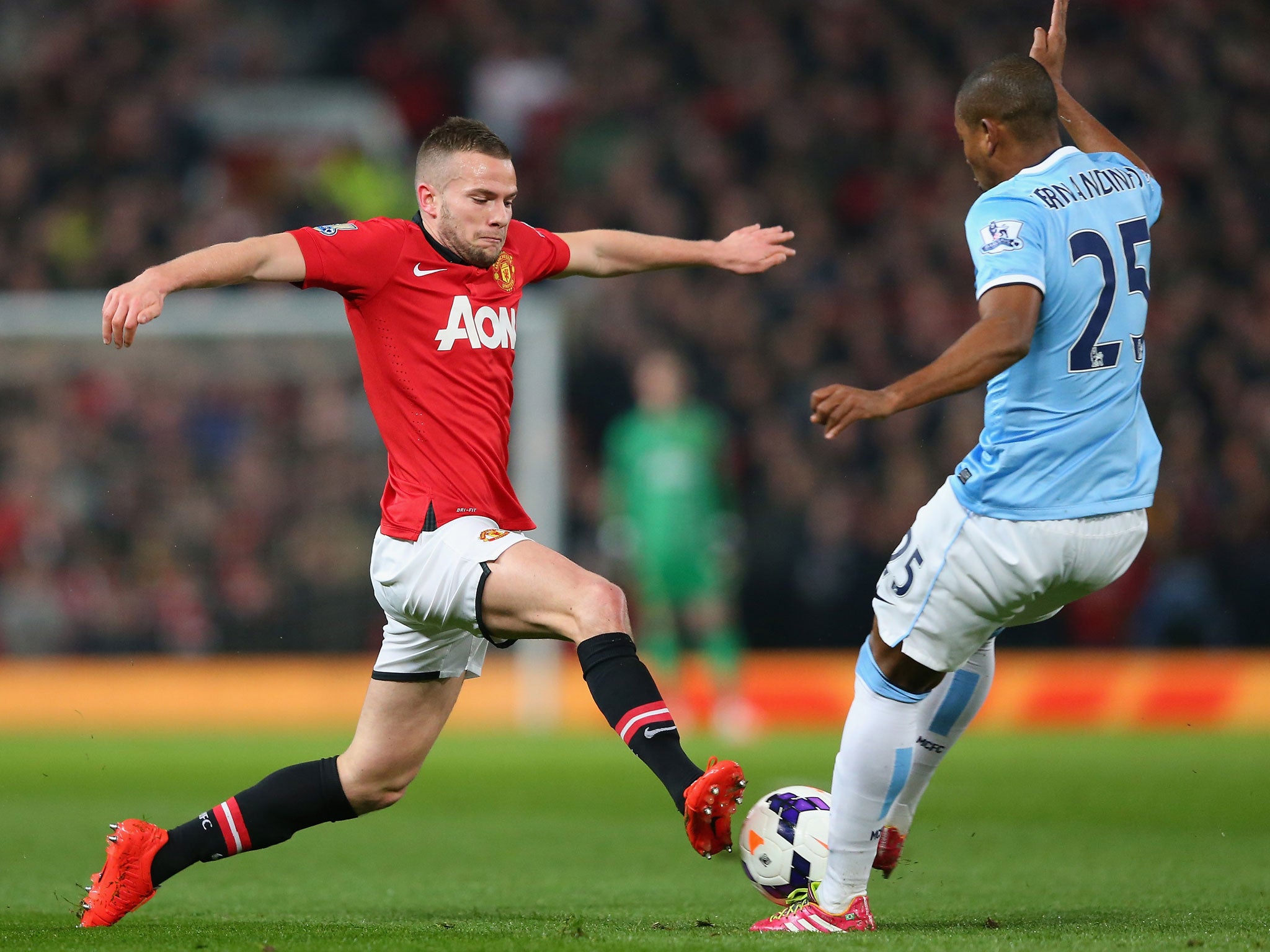 Tom Cleverley (left) competes for the ball with Fernandinho