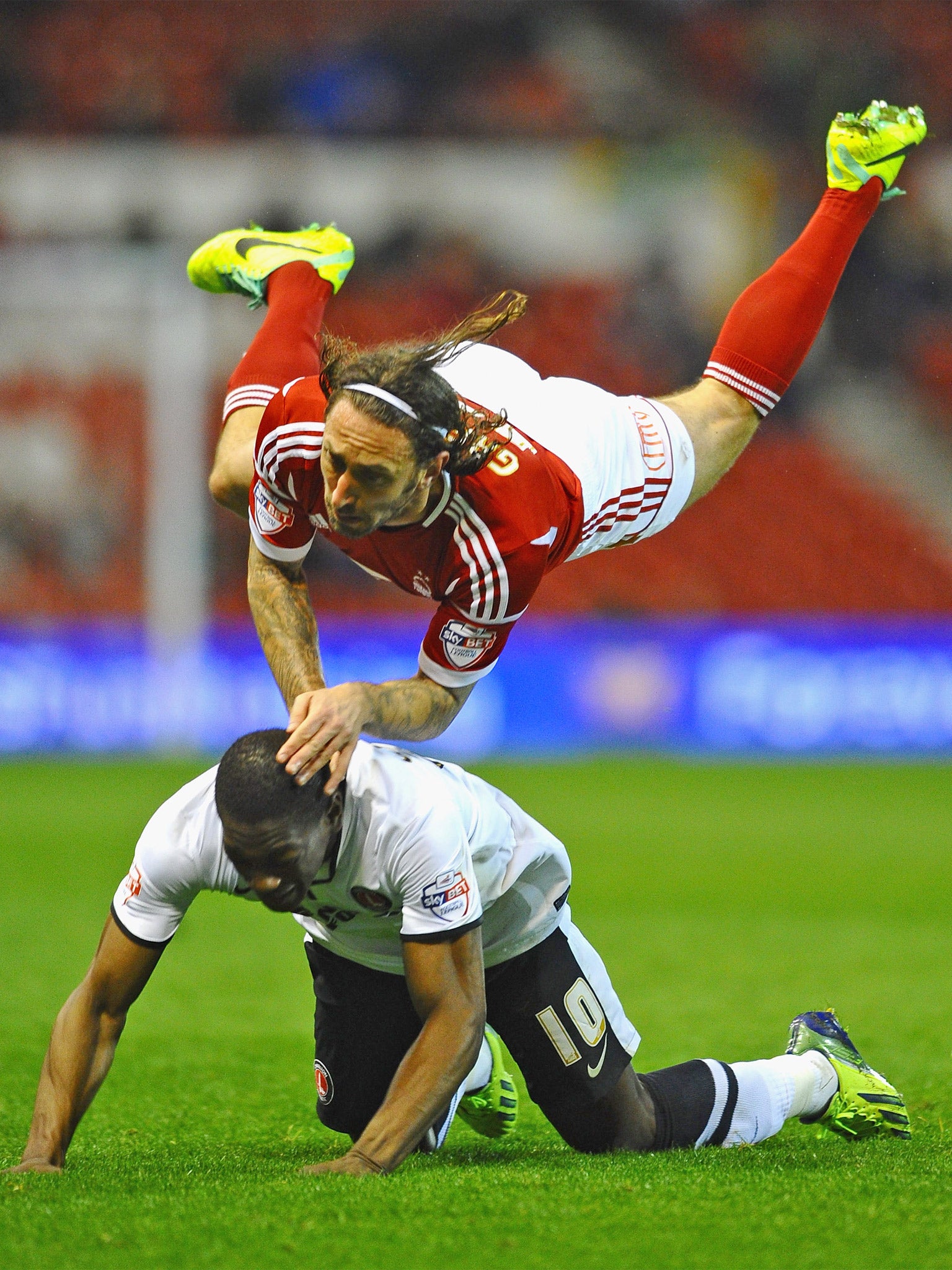 Forest’s Jonathan Greening (top) battles with Marvin Sordell