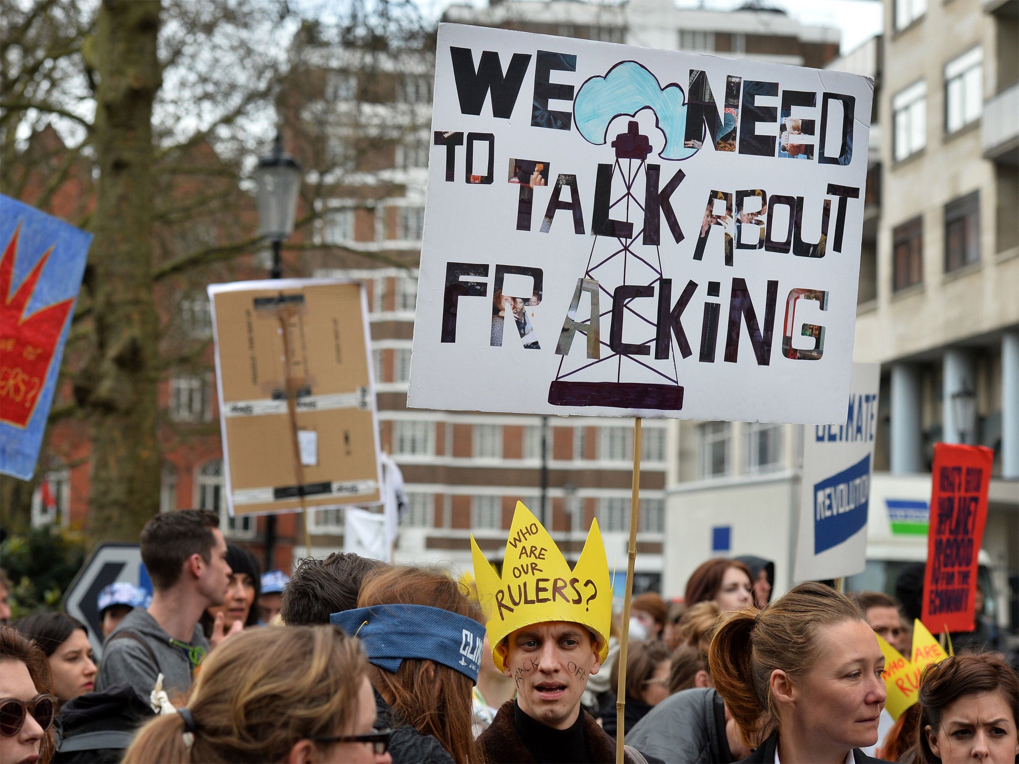 Demonstrators carry placards as they gather for an anti-fracking protest in London