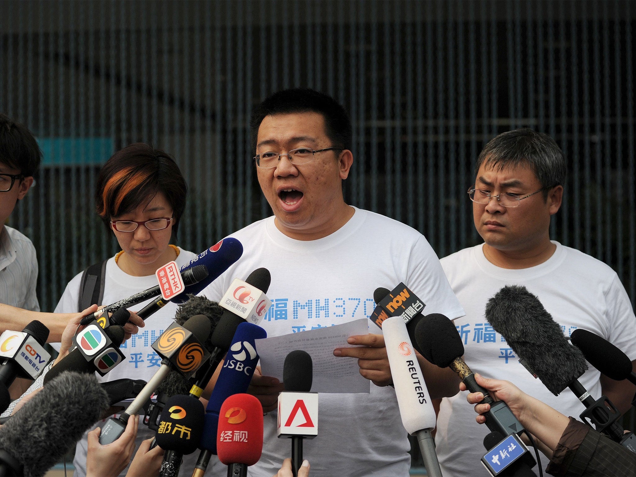 A relative of passengers on the missing Malaysia Airlines flight MH370 speaks to the media at the Metro Park Lido Hotel in Beijing on 26 March