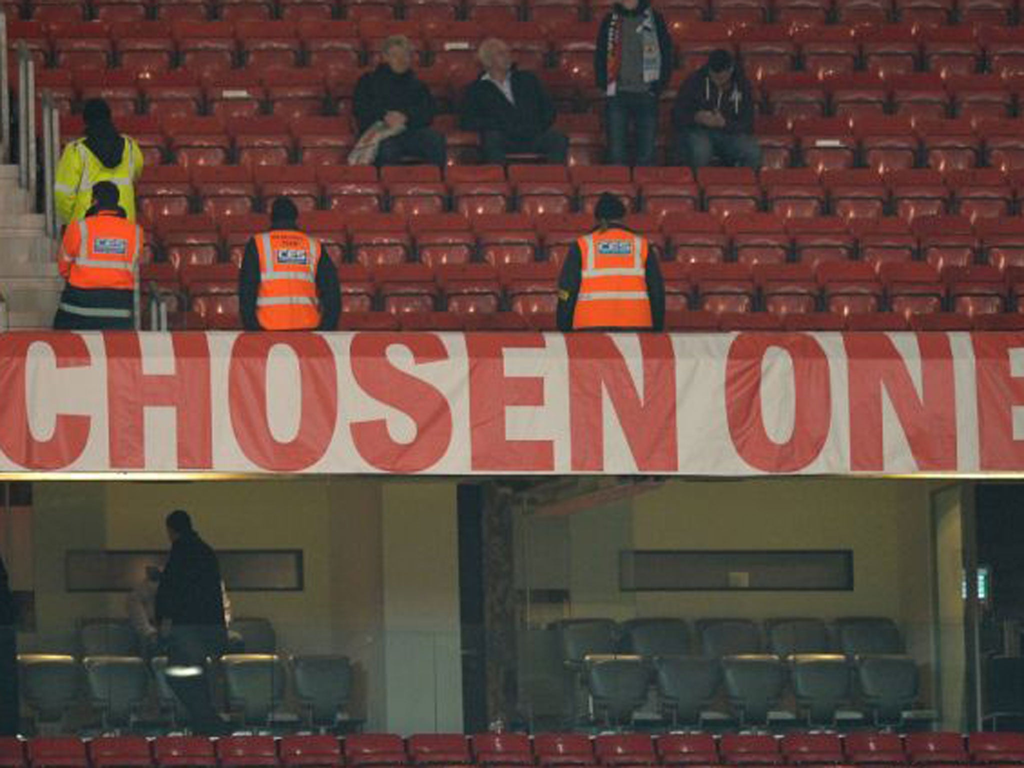 Stewards guard Moyes's banner at Old Trafford last night