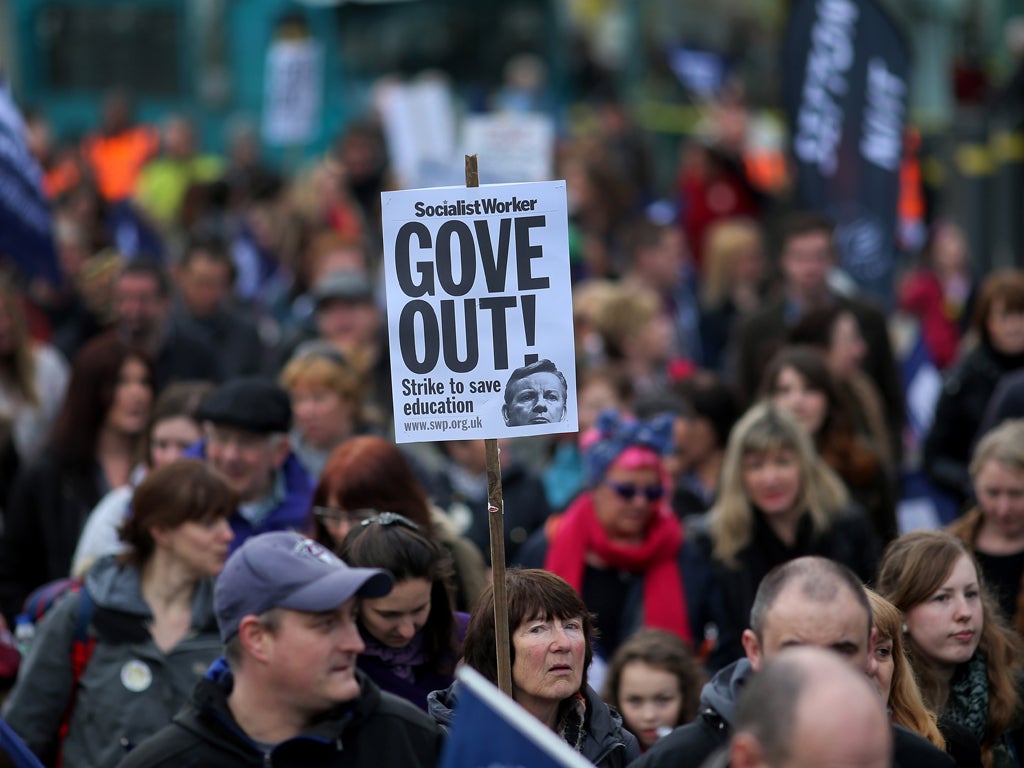 Members of the National Union of Teachers (NUT) take part in a rally during a one-day walkout by teachers across England and Wales on March 26, 2014 in Liverpool, United Kingdom.