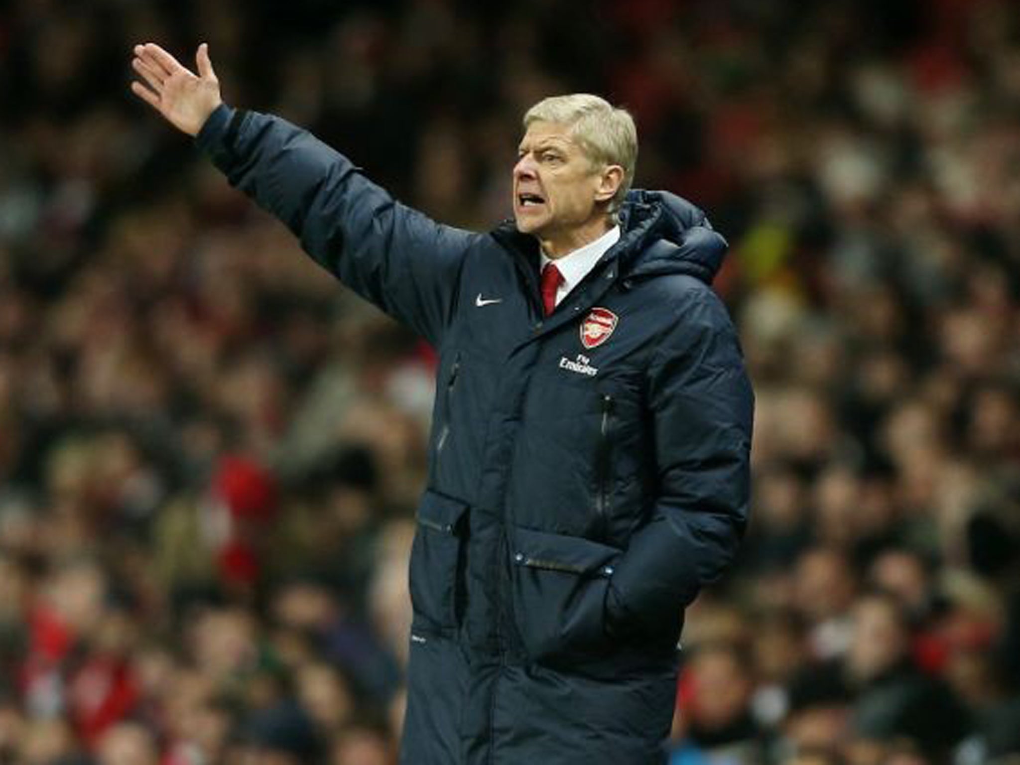 Arsene Wenger makes a gesture from the touchline