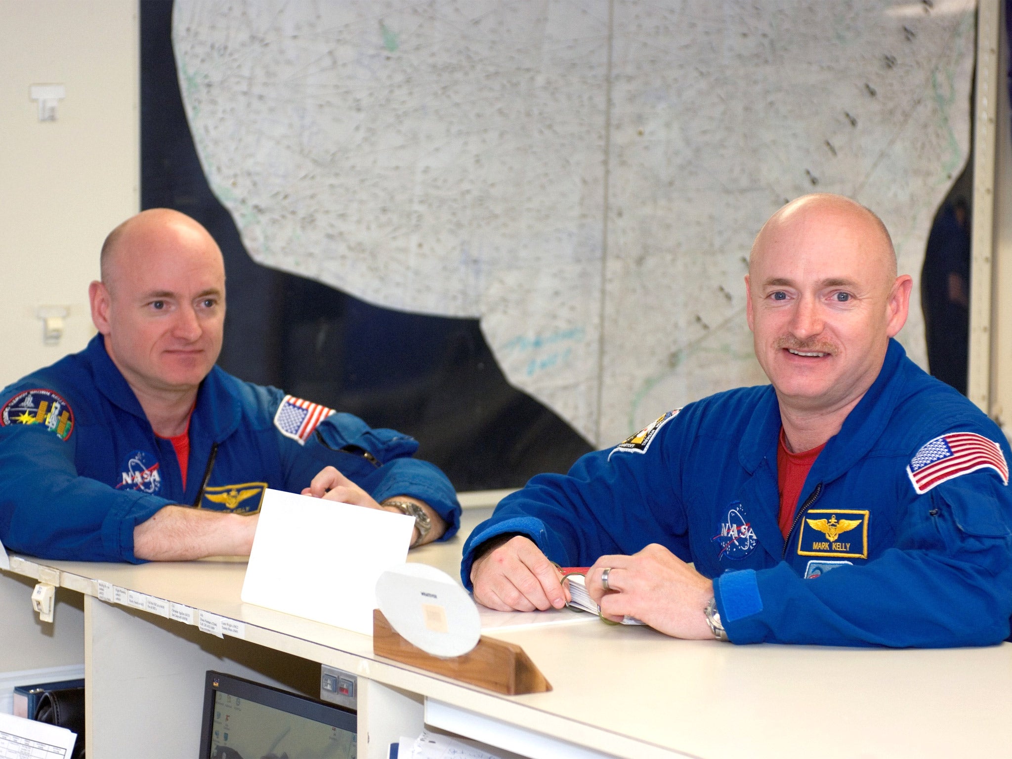 Astronauts Scott, left, and Mark Kelly in the check-out facility at Ellington Field near NASA's Johnson Space Center in Houston