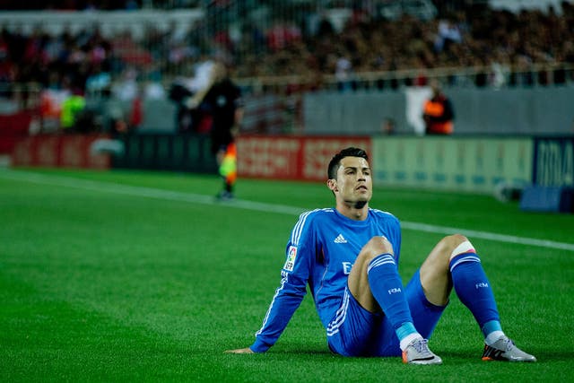 Cristiano Ronaldo of Real Madrid lies on the ground after being tackled during the La Liga defeat to Sevilla 