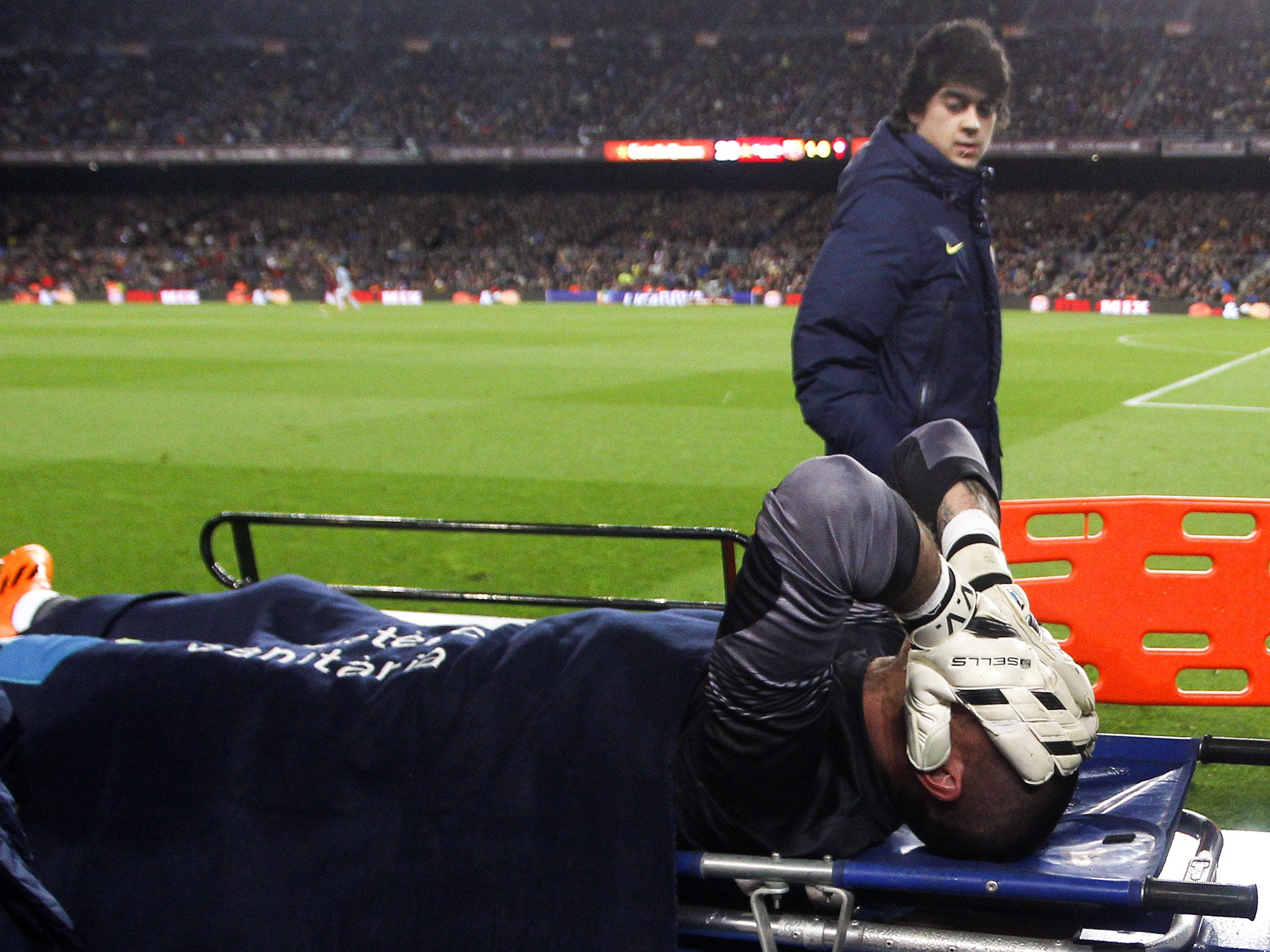 Victor Valdes holds his head in his hands after picking up a serious knee injury while playing for Barcelona
