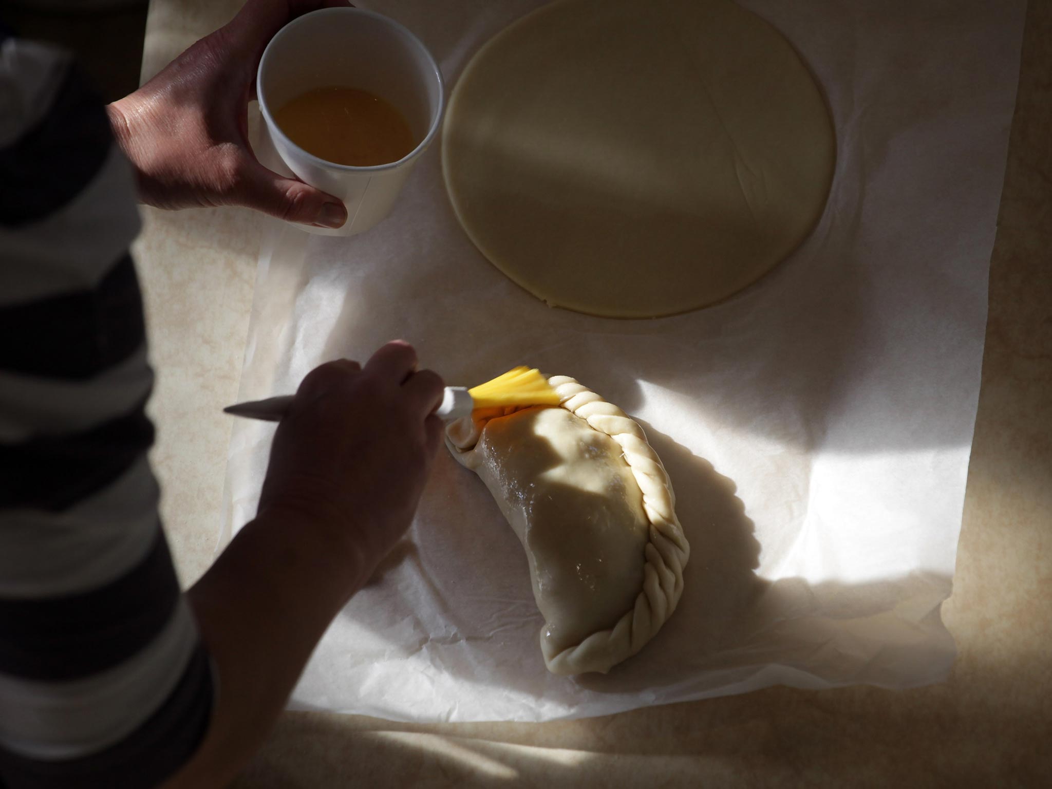 Brush with success: A cook glazes a pasty