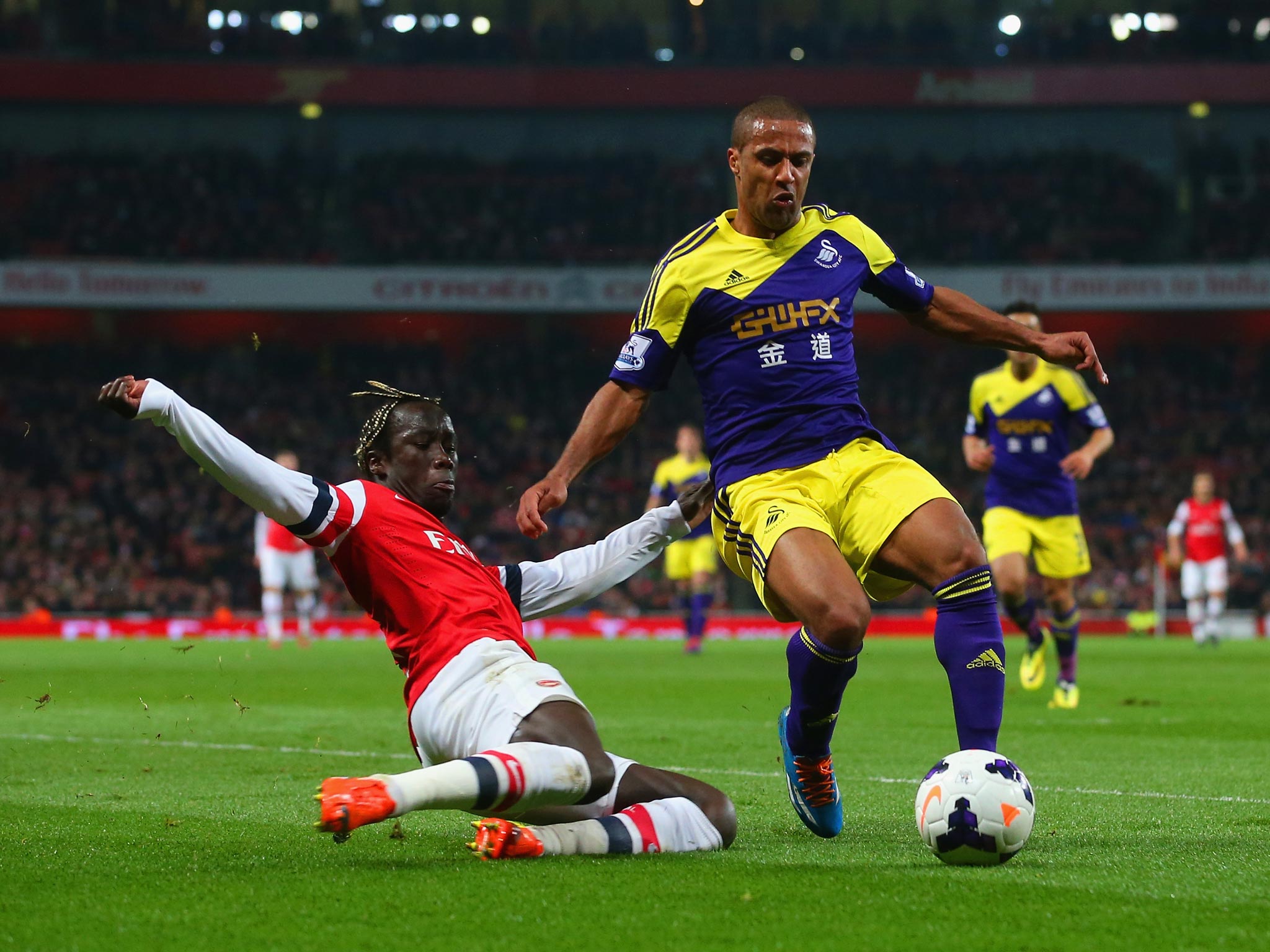 Bacary Sagna tackles Wayne Routledge during the 2-2 draw between Arsenal and Swansea