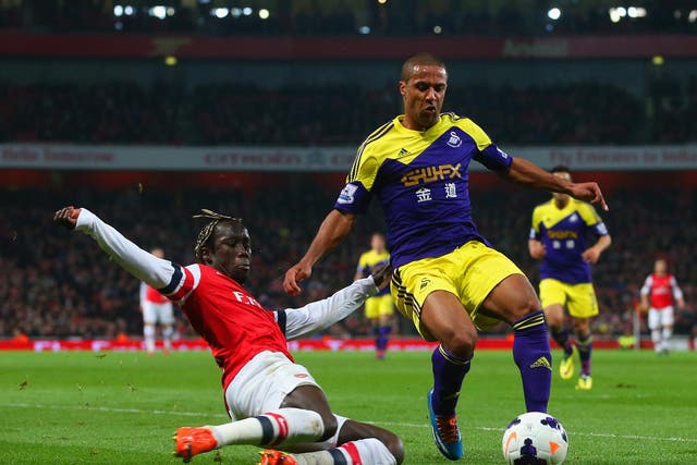 Bacary Sagna tackles Wayne Routledge during the 2-2 draw between Arsenal and Swansea