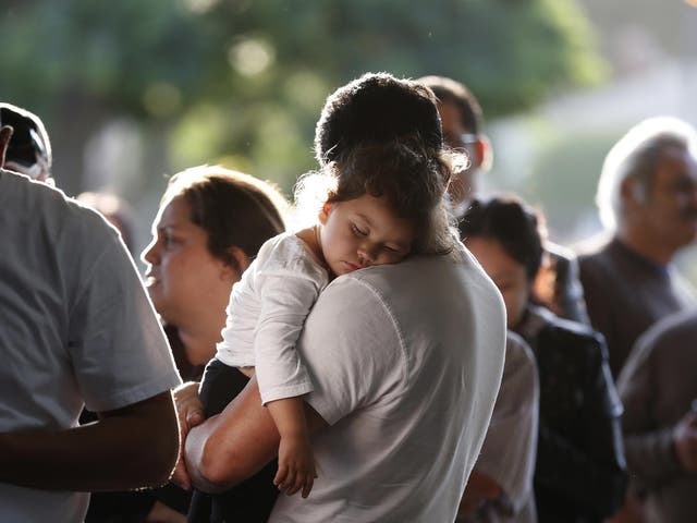 A girl naps while waiting for a health insurance enrollment in California