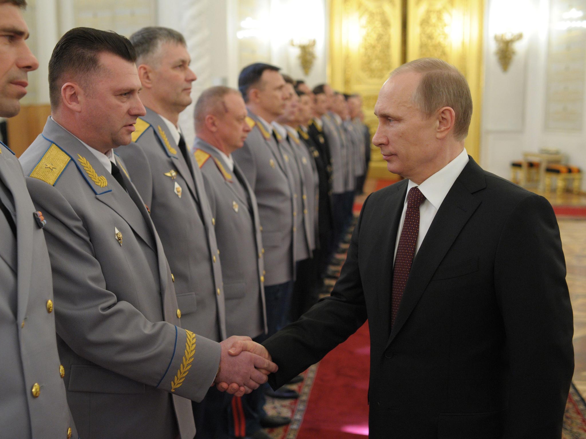 Vladimir Putin meets newly promoted officers yesterday from the Russian armed forces, which he praised for their role in Crimea