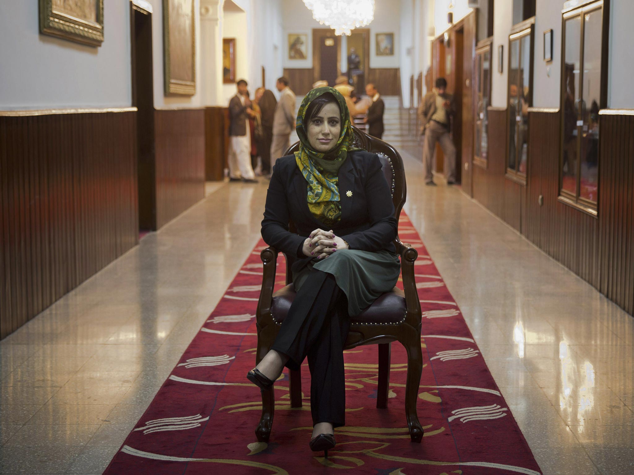 Hamida Ahmadzai, who represents Afghanistanís colorful Kuchi, poses for a picture inside the Afghan parliament in Kabul, Afghanistan