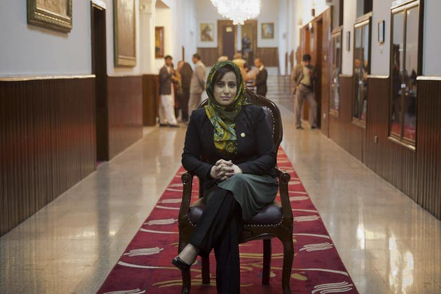 Hamida Ahmadzai, who represents Afghanistanís colorful Kuchi, poses for a picture inside the Afghan parliament in Kabul, Afghanistan
