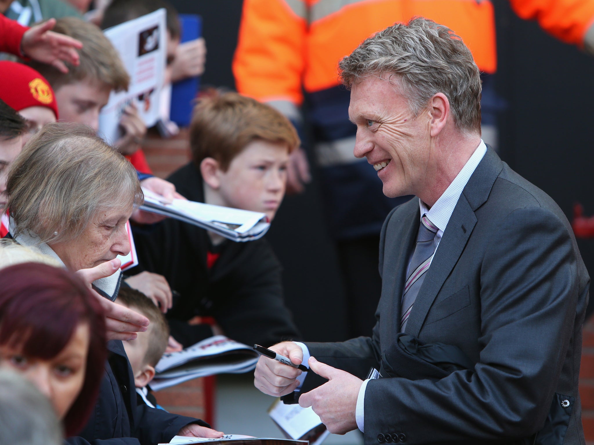 David Moyes grins as he signs autographs for the Manchester United fans