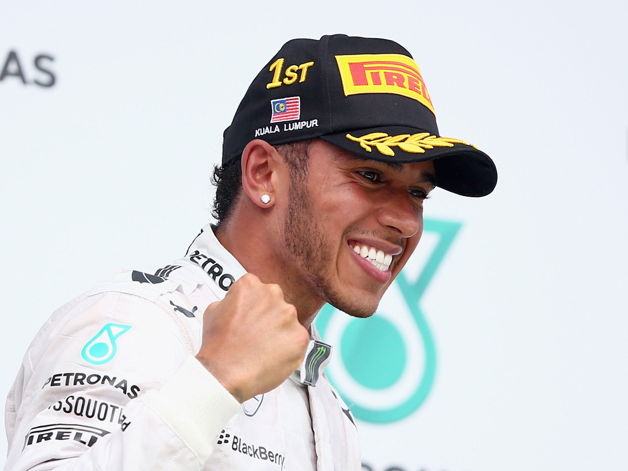 Lewis Hamilton celebrates on the podium after winning the Malaysia Grand Prix