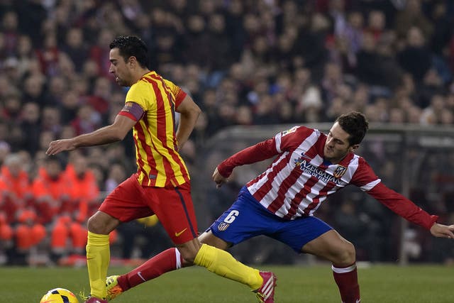 Xavi (left) and Koke vie for the ball during Barcelona's 0-0 La Liga draw at Atletico Madrid in January