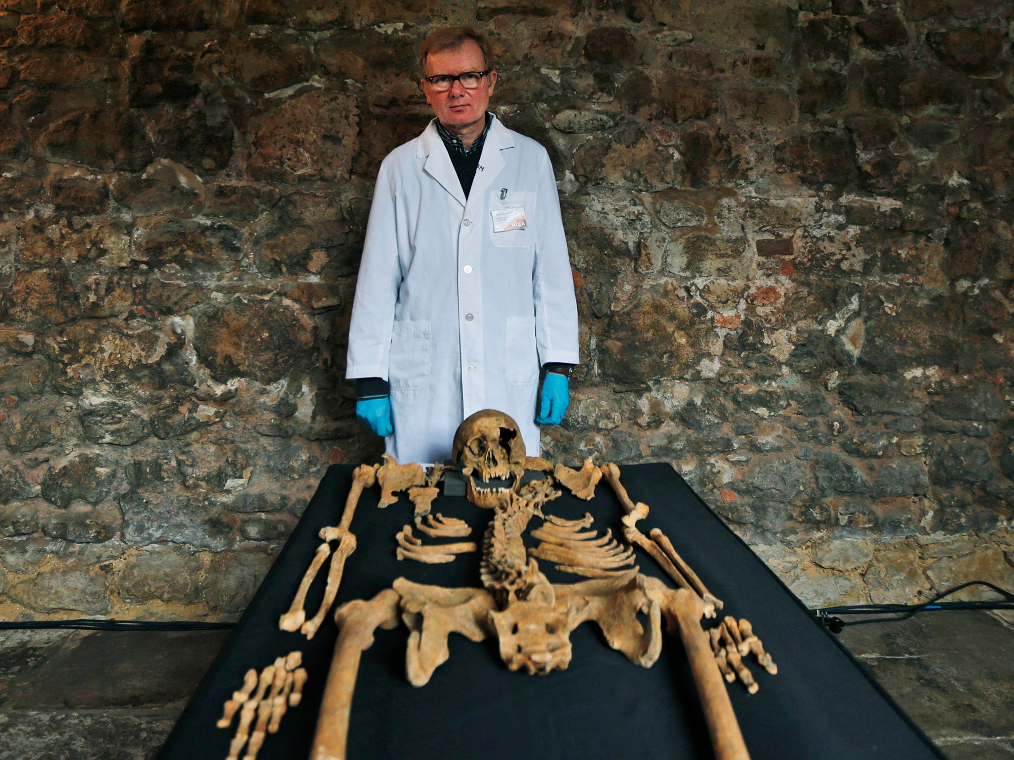 Don Walker, a human osteologist, with one of the skeletons found by construction workers under central London's Charterhouse Square