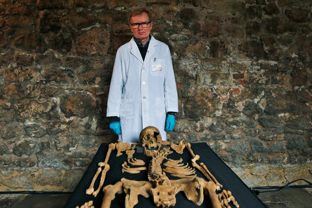 Don Walker, a human osteologist, with one of the skeletons found by construction workers under central London's Charterhouse Square