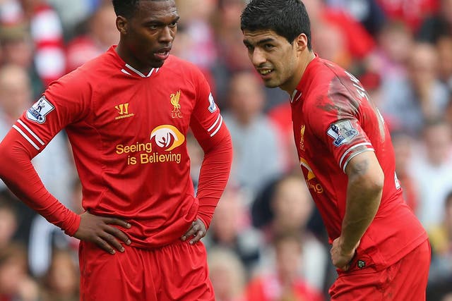 Daniel Sturridge (left) and Luis Suarez speak during Liverpool's 4-0 victory over Tottenham on Sunday