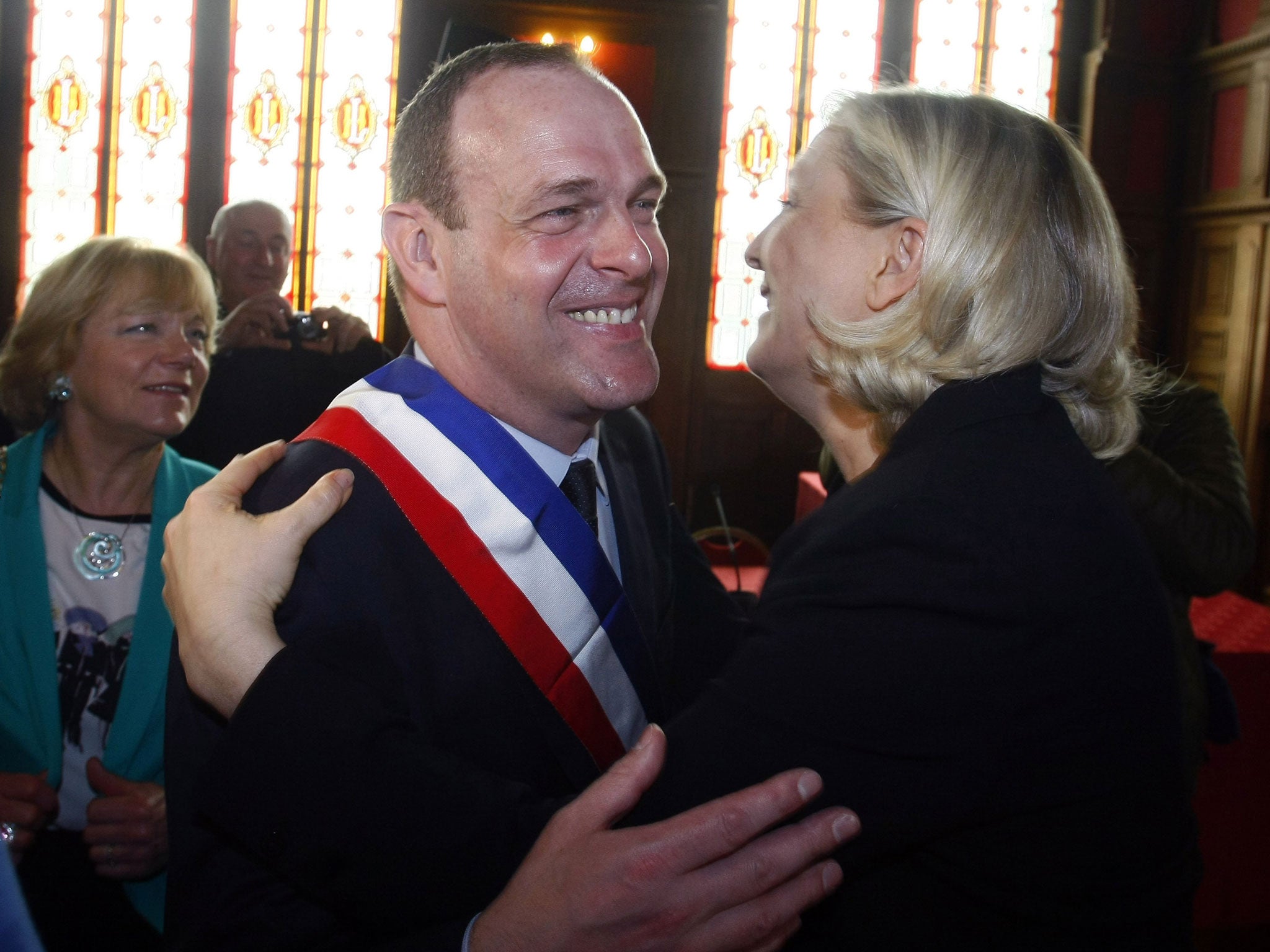 Marine Le Pen, right, the leader of the far-right National Front, congratulates Steeve Briois after he was elected mayor of the northern former mining town of Henin Beaumont