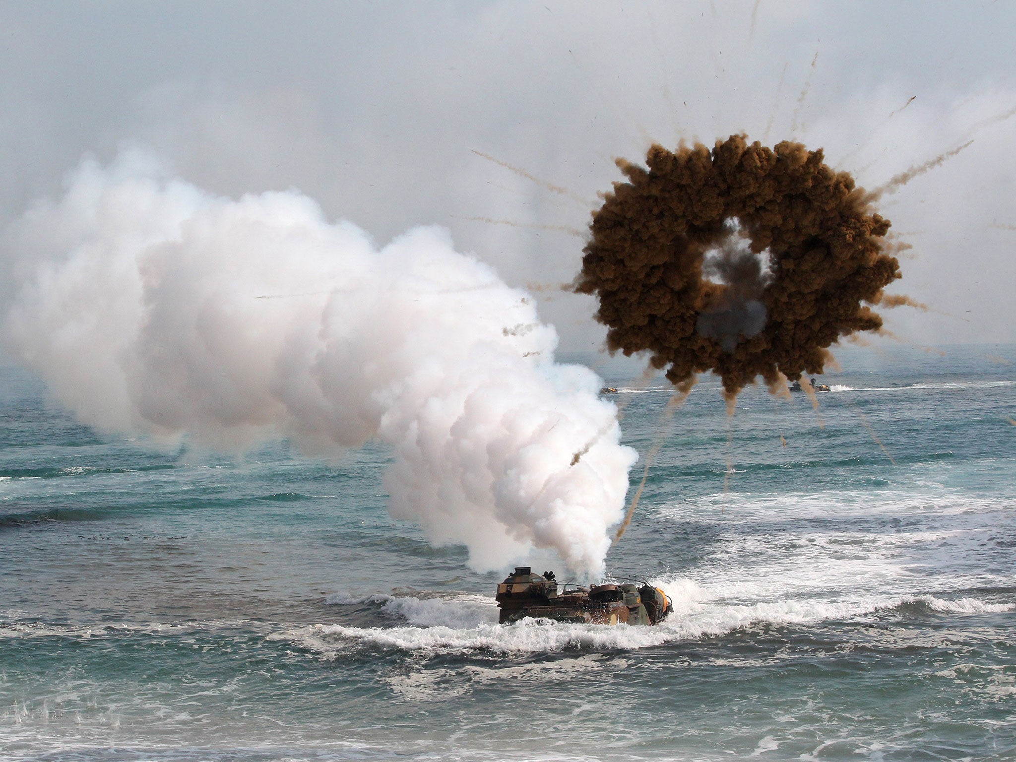 A South Korean marine LVT-7 landing craft sail to shores through a smoke screen during the U.S.-South Korea joint landing exercises called Ssangyong, part of the Foal Eagle military exercises in Pohang